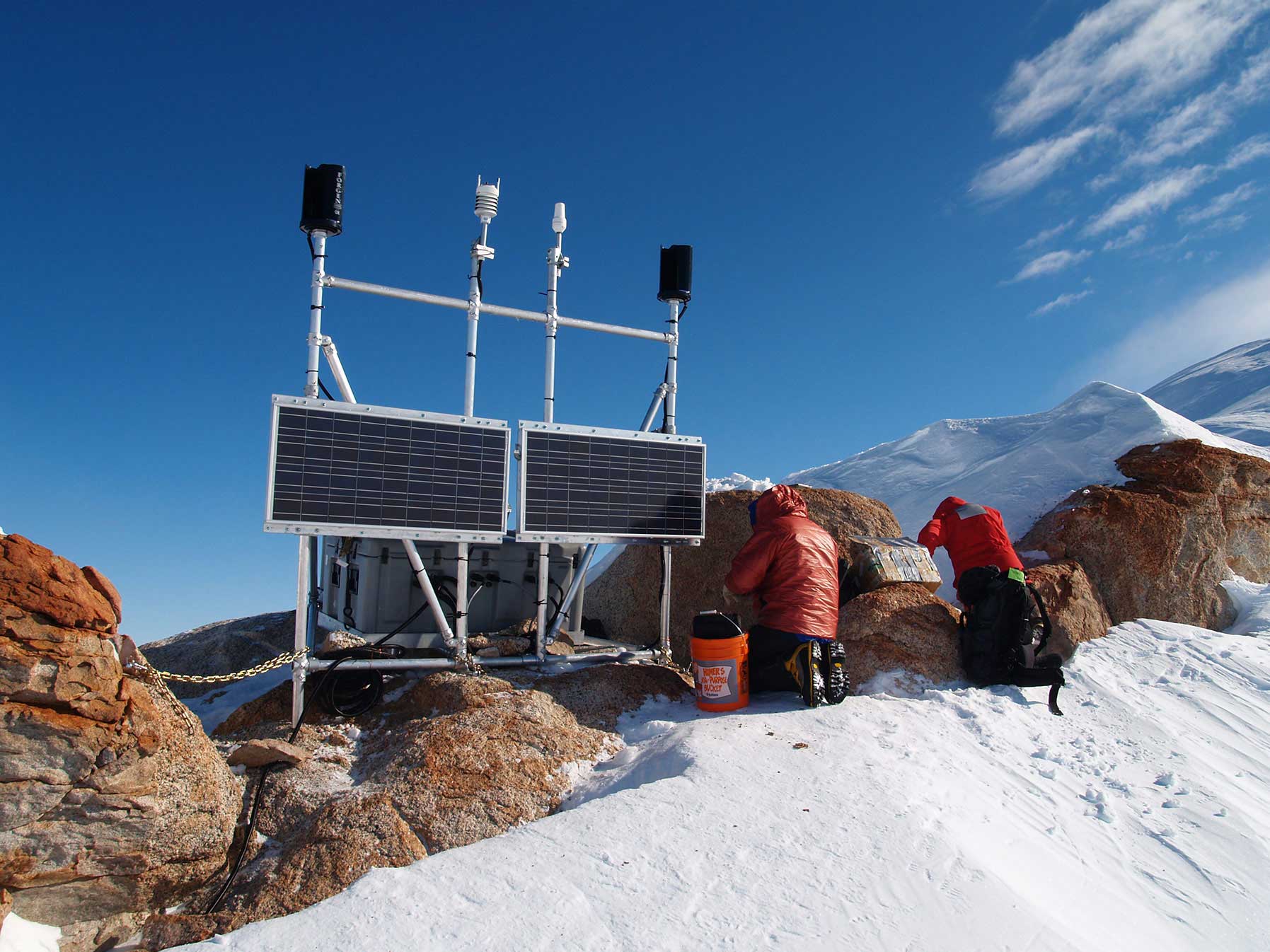 Genasun controllers attached to solar panels in snowy Arctic, suitable for harsh weather conditions with C1D2 classification